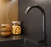 A kitchen counter with a black faucet, wooden bowls, and a jar of nuts. Podgląd zdjęcia produktu