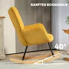 A yellow corduroy rocking chair with wooden rockers is shown in a room with a ribbed wall. Náhled obrázku produktu