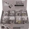 A display box filled with photo keyrings, with the product packaging visible at the top. Produktbild-Vorschau