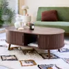 A living room scene with a coffee table, sofa, and rug. Produktbild-Vorschau