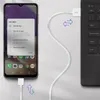 A USB-C cable connecting a smartphone to a laptop, with a pop-up menu on the phone screen showing USB connection options. Náhľad obrázku produktu