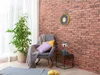 A cozy corner with a chair, plant, and side table. Produktbild-Vorschau