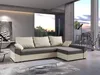 A modern living room with a sectional sofa, coffee table, and large windows overlooking a sunset. Náhled obrázku produktu