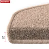 Close-up of a beige carpeted stair mat, showing its textured surface and rounded edge with a measurement indicator. Produktbild-Vorschau