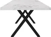 A close-up side view of a rectangular dining table with a white marble-patterned top and black criss-cross legs, set against a plain white background. Náhľad obrázku produktu