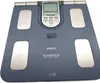 A blue Omron Karada Scan body composition monitor is shown from a top-down perspective. Podgląd zdjęcia produktu