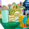 A close-up view of a set of wooden building blocks arranged to form a miniature town, including a museum, police station, and other buildings. Anteprima dell’immagine prodotto