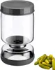 A glass jar with a gray lid and a silver base, next to a pile of small pickles. Anteprima dell’immagine prodotto