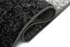 A close-up view of a rolled-up rug, showing the texture and edges. Náhľad obrázku produktu