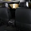 The interior of a car with black leather seat covers installed on the rear seats. Produktbild-Vorschau
