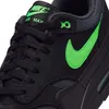 A close-up view of a black Nike Air Max 1 Essential sneaker with green accents. Produktbild-Vorschau