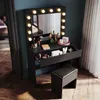 A vanity table with lights and makeup products is set up in a room with a window and curtains. Anteprima dell’immagine prodotto