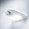 A white motion-activated LED ceiling light with a sensor is mounted on a textured white wall. Voir les images du produit