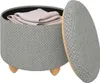 A round storage ottoman with its lid open, revealing folded fabric inside. The ottoman has a textured gray fabric exterior and wooden legs. Produktbild-Vorschau