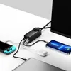 A black GaN charger is shown connected to a monitor, a smartphone, a Nintendo Switch, and a laptop, demonstrating its multi-device charging capabilities. Anteprima dell’immagine prodotto