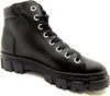 A black leather high-top boot with a thick lug sole, shown from a side angle against a white background. Voir les images du produit