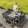 A couple is enjoying a meal at a table on a wooden deck, surrounded by grass. Produktbild-Vorschau