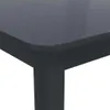 A close-up view of the corner of a dark-colored table, showing the rounded edge and a table leg. Anteprima dell’immagine prodotto