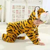 A baby wearing a tiger costume is crawling on a carpet. Produktbild-Vorschau