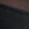 A close-up view of the texture of a brown fabric and a black fabric with small white dots. Náhled obrázku produktu