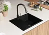 A black granite kitchen sink with a black faucet is shown on a white countertop, with some decorative items in the background. Produktbild-Vorschau