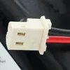 Close-up of a white electrical connector with red and black wires attached. Podgląd zdjęcia produktu