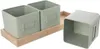 Three green metal pots, two on a wooden tray and one beside it. Produktbild-Vorschau