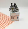 A Stihl carburetor is placed on top of its packaging box, with a piece of protective paper in the foreground. Produktbild-Vorschau