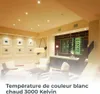 A modern living room with recessed ceiling lights, a wine display cabinet, and seating. Voir les images du produit