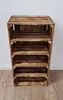 A wooden crate shelf unit with four shelves, standing on a wooden floor against a white wall. Náhled obrázku produktu
