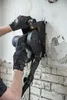 A person wearing gloves is using a wall slotter machine to cut a groove in a brick wall. Náhled obrázku produktu
