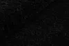 A close-up, textured view of a black rug. Voir les images du produit