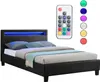A black upholstered bed with blue LED lighting in the headboard and a remote control. Produktbild-Vorschau