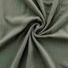 A close-up view of green muslin fabric, showing its textured weave and soft folds. Voir les images du produit
