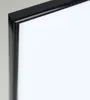 A close-up view of the corner of a black picture frame with a white background. Produktbild-Vorschau