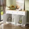 A white sideboard with a wooden top, featuring open doors revealing storage compartments, set against a light green wall with blinds and a window on the left. Voir les images du produit