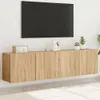 A wall-mounted TV cabinet with a television above it. Náhľad obrázku produktu