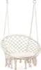 A white macrame hammock chair with a cushion, suspended by ropes. Náhled obrázku produktu