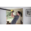 A man is performing a suspension training exercise using TRX straps indoors. Produktbild-Vorschau