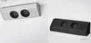 A split image showing two different colored electrical outlet units mounted on a wall. Voir les images du produit