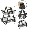A two-tiered metal fruit basket with a wooden handle, shown with close-up details of its construction. Produktbild-Vorschau