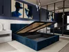 A bedroom with a dark blue upholstered bed frame with the storage lift mechanism open, revealing the storage space underneath. Two abstract blue paintings hang on the wall above the bed. Náhľad obrázku produktu
