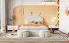 A child's bedroom with a bed, nightstand, and rug. Náhled obrázku produktu