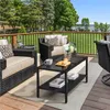 A patio set with chairs and a coffee table on a wooden deck overlooking a grassy area and a body of water. Produktbild-Vorschau