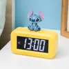 A yellow digital alarm clock with a Stitch figurine on top, displaying the time 13:00. Anteprima dell’immagine prodotto