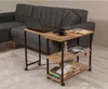 A side table with a laptop, cup, book, and bottle next to a sofa. Voir les images du produit
