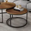 A close-up view of two round coffee tables, one nested under the other, in a living room setting. Anteprima dell’immagine prodotto