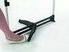A person's foot wearing a white ballet flat is pressing down on a black mechanism of a drying rack. Voir les images du produit