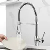 A hand is washing a plate under a kitchen faucet. Náhled obrázku produktu
