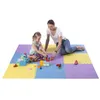 A woman and a child are playing with building blocks on a colorful puzzle mat. Voir les images du produit